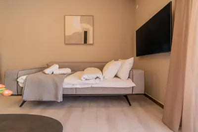 a living room with a couch with two pillows at Elegant Suite Syntagma A2 in Athens