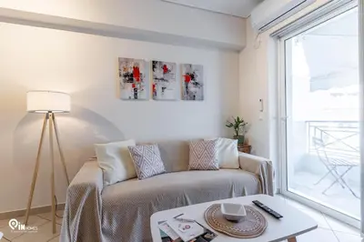 a living room with a couch and a table at Suite Escape - Cozy House in Egaleo-Athens in Athens