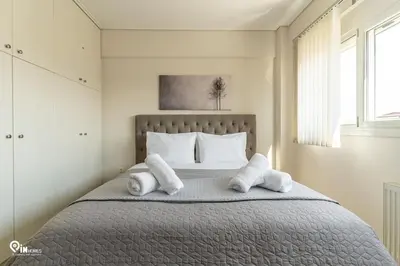 a bedroom with a bed with towels on it at Suite Escape - Cozy House in Egaleo-Athens in Athens