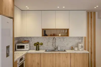 a kitchen with white cabinets and a sink and a microwave at City & Sea in Athens