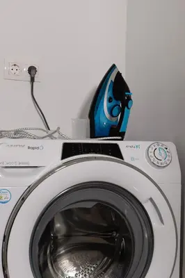 a washing machine with a bottle on top of it at City & Sea in Athens
