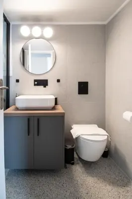 a bathroom with a sink and a toilet and a mirror at Olympian Zeus top location in Athens
