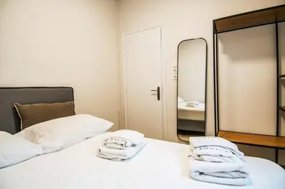a bedroom with a white bed and a mirror at Olympian Zeus top location in Athens