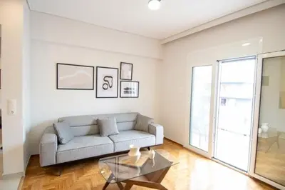 a living room with a couch and a glass table at Olympian Zeus top location in Athens