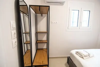 a mirror leaning against a wall next to a bed at Olympian Zeus top location in Athens