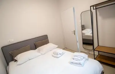 a bedroom with a white bed with a mirror at Olympian Zeus top location in Athens