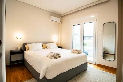 a bedroom with a large bed and a large mirror at Olympian Zeus top location in Athens