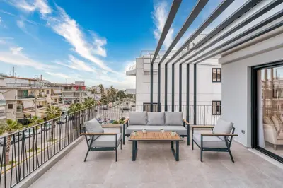 a balcony with a couch and chairs and a table at Elegant Penthouse 2 BRs - Large Veranda with View in Athens