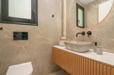 a bathroom with a sink and a mirror at Elegant Penthouse 2 BRs - Large Veranda with View in Athens