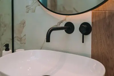 a bathroom with a white sink and a mirror at Elegant Penthouse 2 BRs - Large Veranda with View in Athens