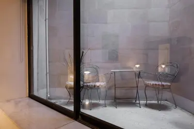 a glass window with two chairs and a table at The Acropolis Mansion in Athens