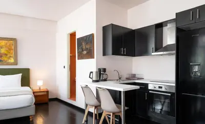 a kitchen with a table and chairs in a room at The Acropolis Mansion in Athens