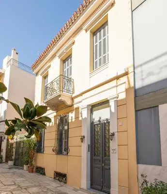 a house with a balcony on a street at The Acropolis Mansion in Athens