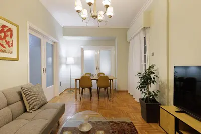 a living room with a couch and a table at Athens Koukaki Penthouse, Acropolis view in Athens