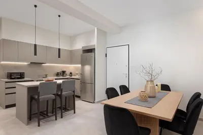 a kitchen and dining room with a table and chairs at Athens Luxury Ethereal Stay in Athens