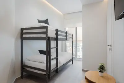 a bedroom with two bunk beds and a table at Athens Luxury Ethereal Stay in Athens