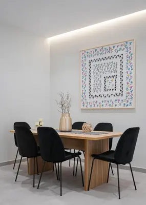 a dining room table with chairs and a picture on the wall at Athens Luxury Ethereal Stay in Athens