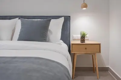 a bedroom with a bed and a nightstand with a plant at Athens Luxury Ethereal Stay in Athens
