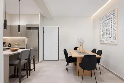 a kitchen and dining room with a table and chairs at Athens Luxury Ethereal Stay in Athens