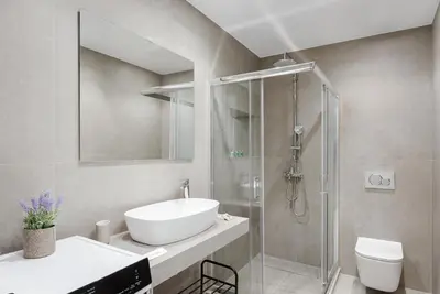 a bathroom with a sink and a shower and a toilet at Athens Luxury Ethereal Stay in Athens