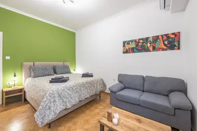 a bedroom with a bed and a couch at Stylish Luxury Apartment at Ampelokipi metro station in Athens