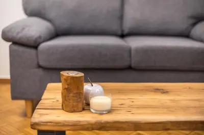 a coffee table with a glass of milk and a couch at Stylish Luxury Apartment at Ampelokipi metro station in Athens