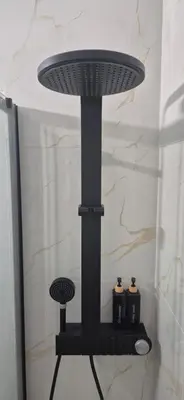 a black table with two bottles on a shelf in a bathroom at Stylish Luxury Apartment at Ampelokipi metro station in Athens