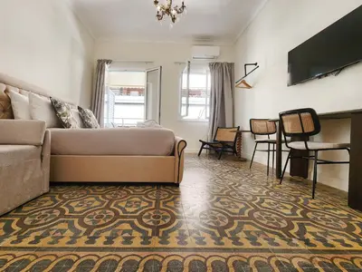 a living room with a couch and a table at Emerald House Rooftop & Stylish Apartments In Central Athens in Athens