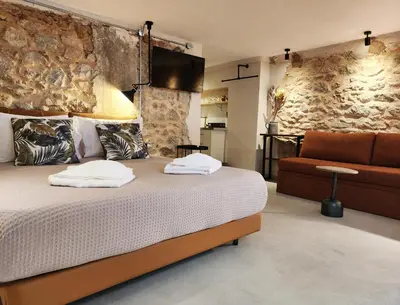 a bedroom with a large bed and a couch at Emerald House Rooftop & Stylish Apartments In Central Athens in Athens