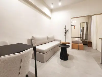 a living room with a couch and a table at Emerald House Rooftop & Stylish Apartments In Central Athens in Athens