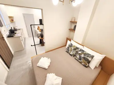 a small room with a couch and a mirror at Emerald House Rooftop & Stylish Apartments In Central Athens in Athens