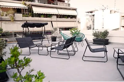 a group of chairs and tables on a patio at Emerald House Rooftop & Stylish Apartments In Central Athens in Athens