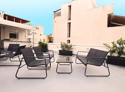 a group of chairs and tables on a patio at Emerald House Rooftop & Stylish Apartments In Central Athens in Athens