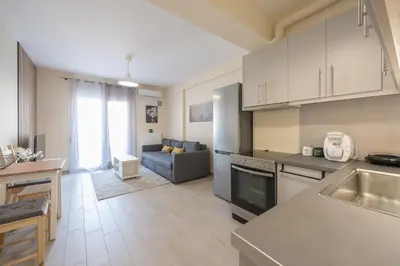 a kitchen and living room with a couch in it at Casa Ilioupoli in Athens