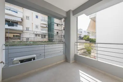 an apartment balcony with views of a building at Casa Ilioupoli in Athens