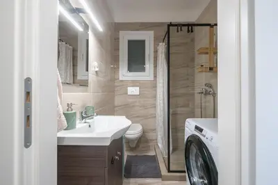a bathroom with a sink and a toilet and a shower at Casa Ilioupoli in Athens