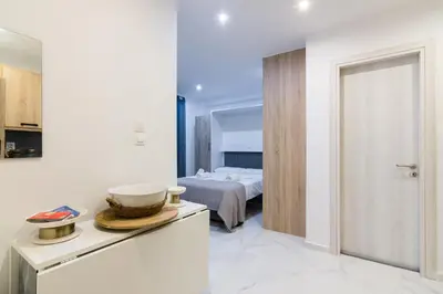 a room with a bedroom with a bed in the background at Modern Studio in Piraeus in Piraeus