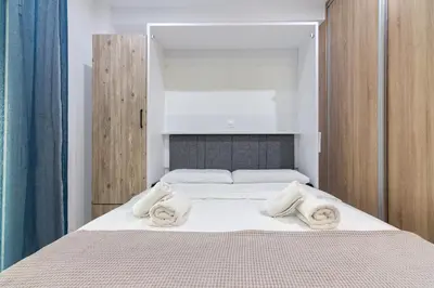 a bedroom with a bed with towels on it at Modern Studio in Piraeus in Piraeus