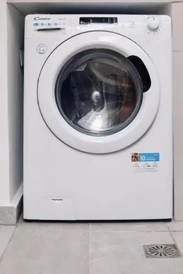 a white washing machine sitting in a room at La Stella Apartment Thisio in Athens