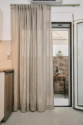 a curtain in a room with a window at La Stella Apartment Thisio in Athens