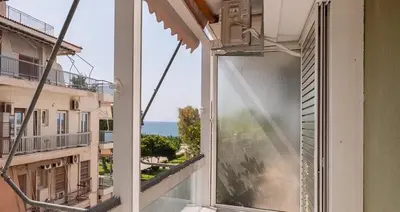 an open balcony with a view of the ocean at Kalamaki Beach Apartment in Athens