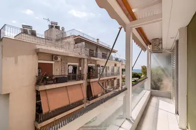a balcony with a view of a building at Kalamaki Beach Apartment in Athens