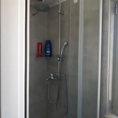 a shower with a shower head in a bathroom at Super central loft - Acropolis metro, museum in Athens