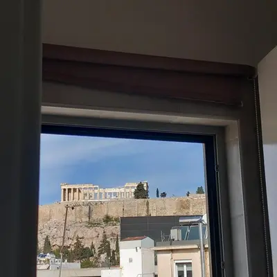 a view of the acropolis from a window at Super central loft - Acropolis metro, museum in Athens