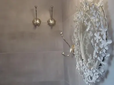a bathroom with a chandelier on the wall at Super central loft - Acropolis metro, museum in Athens