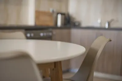 a white table and chairs in a kitchen at Oasis Neos Kosmos Modern Apt near Acropolis in Athens
