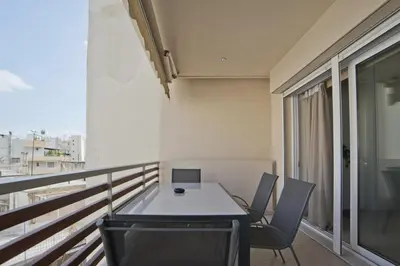 a room with a table and chairs on a balcony at Oasis Neos Kosmos Modern Apt near Acropolis in Athens