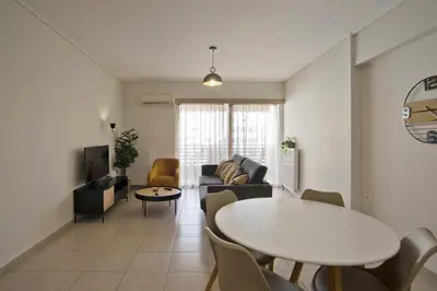a living room with a table and a couch at Oasis Neos Kosmos Modern Apt near Acropolis in Athens