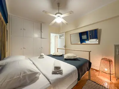 a bedroom with a bed and a ceiling fan at Athina in Athens 5 min to Metro Station in Athens