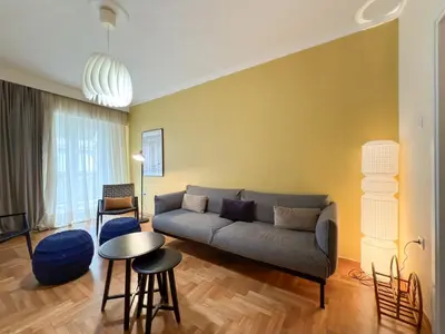 a living room with a couch and a table at Athina in Athens 5 min to Metro Station in Athens